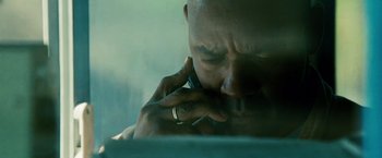 Movie still from “Unstoppable” (2010), directed by Tony Scott – A person talking on a cell phone; Extreme Close Up shot, Low angle