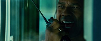 Movie still from “Unstoppable” (2010), directed by Tony Scott – A person holding a walkie talkie; Extreme Close Up shot, Low angle