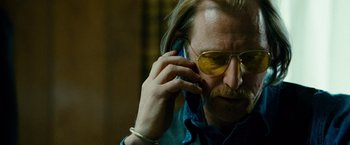 Movie still from “Unstoppable” (2010), directed by Tony Scott – A man with long blonde hair talking on a cell phone; Close Up shot, Low angle