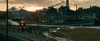 Movie still from “Unstoppable” (2010), directed by Tony Scott – A view of a train track and a building; Extreme Wide shot, High angle