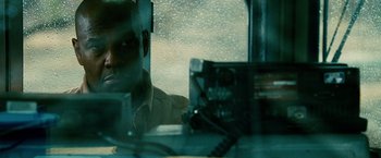 Movie still from “Unstoppable” (2010), directed by Tony Scott – A man sitting in a car looking out the window; Close Up shot, Over the shoulder angle