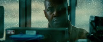 Movie still from “Unstoppable” (2010), directed by Tony Scott – A person looking out of a car window; Close Up shot, Over the shoulder angle