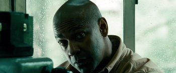 Movie still from “Unstoppable” (2010), directed by Tony Scott – A man with a bald head looking at the camera; Close Up shot, Low angle