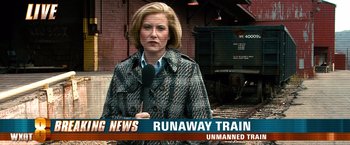 Movie still from “Unstoppable” (2010), directed by Tony Scott – A woman is standing in front of a microphone; Extreme Wide shot, High angle