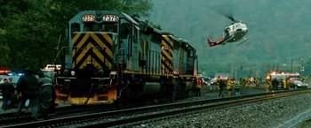 Movie still from “Unstoppable” (2010), directed by Tony Scott – A train on a train track near a forest; Extreme Wide shot, Low angle