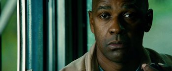 Movie still from “Unstoppable” (2010), directed by Tony Scott – A man's face in front of a window; Close Up shot, Low angle