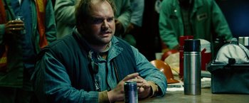 Movie still from “Unstoppable” (2010), directed by Tony Scott – A man sitting at a table in front of a can of soda; Close Up shot, Over the shoulder angle
