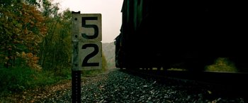 Movie still from “Unstoppable” (2010), directed by Tony Scott – A train traveling down train tracks next to trees; Extreme Close Up shot, High angle