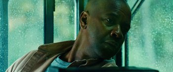 Movie still from “Unstoppable” (2010), directed by Tony Scott – A man's face in front of a window; Close Up shot, Low angle