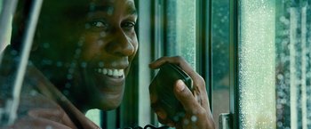 Movie still from “Unstoppable” (2010), directed by Tony Scott – A man holding a cell phone up to his face; Close Up shot, Over the shoulder angle