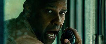 Movie still from “Unstoppable” (2010), directed by Tony Scott – A person talking on a cell phone; Close Up shot, Low angle