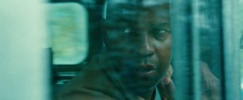 Movie still from “Unstoppable” (2010), directed by Tony Scott – A man's face through a window; Close Up shot, Over the shoulder angle