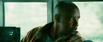 Movie still from “Unstoppable” (2010), directed by Tony Scott – A man sitting in front of a window; Close Up shot, Low angle