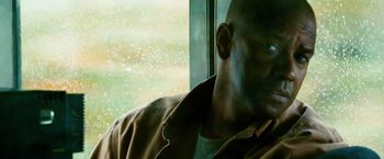 Movie still from “Unstoppable” (2010), directed by Tony Scott – A person looking out of a window; Close Up shot, Low angle