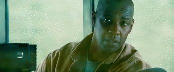 Movie still from “Unstoppable” (2010), directed by Tony Scott – A person looking out of a window; Close Up shot, Low angle