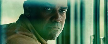 Movie still from “Unstoppable” (2010), directed by Tony Scott – A man's face in a green room; Extreme Close Up shot, Low angle
