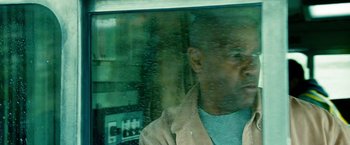Movie still from “Unstoppable” (2010), directed by Tony Scott – A man looking out of a train window; Close Up shot, Low angle