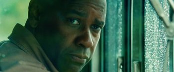Movie still from “Unstoppable” (2010), directed by Tony Scott – A man's face in front of a window; Close Up shot, Low angle