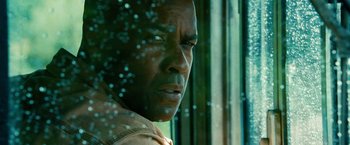 Movie still from “Unstoppable” (2010), directed by Tony Scott – A person looking out a window; Close Up shot, Low angle