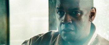 Movie still from “Unstoppable” (2010), directed by Tony Scott – A man's face in front of a window; Close Up shot, Low angle