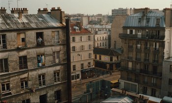 Movie still from “Until the End of the World” (1991), directed by Wim Wenders – An aerial view of a city with many buildings; Extreme Wide shot, High angle