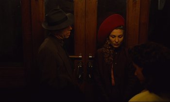 Movie still from “Until the End of the World” (1991), directed by Wim Wenders – A man and a woman standing next to each other; Medium shot, Overhead angle