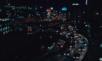 Movie still from “Until the End of the World” (1991), directed by Wim Wenders – A view of a busy city at night with lights on; Extreme Wide shot, High angle