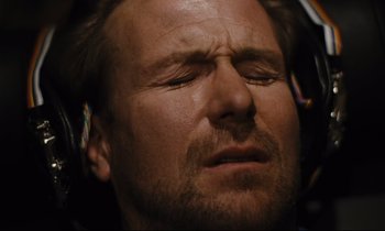 Movie still from “Until the End of the World” (1991), directed by Wim Wenders – A person with his eyes closed; Close Up shot, Overhead angle