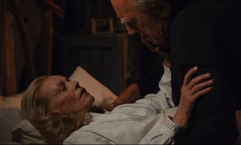 Movie still from “Until the End of the World” (1991), directed by Wim Wenders – An older man and a younger woman in a room; Close Up shot, High angle
