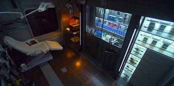 Movie still from “Another Life” (2019), created by Aaron Martin – A view of a room from the inside of a train; Extreme Wide shot, Overhead angle