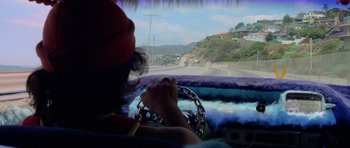 A clown driving a car on a road