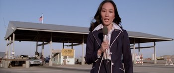 A woman is holding a microphone in her hand