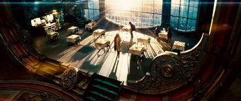 People are sitting at tables in an open room