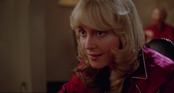 Movie still from “Used Cars” (1980), directed by Robert Zemeckis – A person wearing a red jacket; Close Up shot, Over the shoulder angle