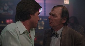 Movie still from “Used Cars” (1980), directed by Robert Zemeckis – A man and an older man talking to each other; Close Up shot, Over the shoulder angle