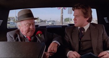 Movie still from “Used Cars” (1980), directed by Robert Zemeckis – Two men sitting in the back seat of a car; Close Up shot, Over the shoulder angle