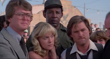Movie still from “Used Cars” (1980), directed by Robert Zemeckis – A group of people standing next to each other; Close Up shot, Low angle