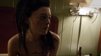 Movie still from “V/H/S” (2012), directed by Joe Swanberg – A beautiful woman with long black hair looking into the mirror; Close Up shot, Over the shoulder angle