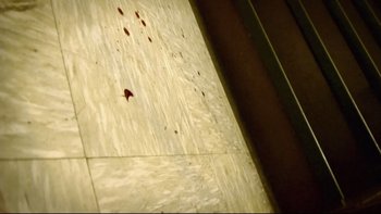Movie still from “V/H/S” (2012), directed by Joe Swanberg – View of a wall with blood on it; Extreme Close Up shot, Overhead angle
