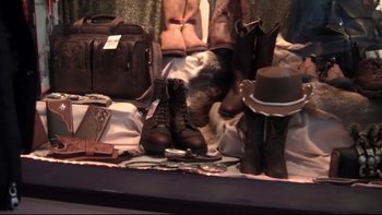 Movie still from “V/H/S” (2012), directed by Joe Swanberg – A display case filled with boots and a hat; Extreme Close Up shot, High angle