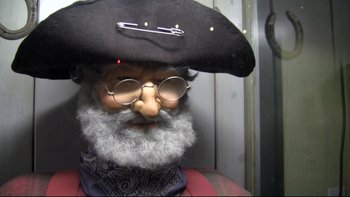 Movie still from “V/H/S” (2012), directed by Joe Swanberg – The face of an old man wearing a hat and glasses; Extreme Close Up shot, High angle