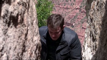 Movie still from “V/H/S” (2012), directed by Joe Swanberg – A man in a black jacket is climbing a tree; Medium shot, Low angle