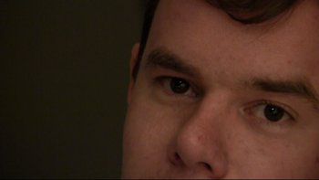 Movie still from “V/H/S” (2012), directed by Joe Swanberg – A man's eye and his face; Extreme Close Up shot, Over the shoulder angle