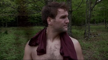 Movie still from “V/H/S” (2012), directed by Joe Swanberg – A man with a towel around his neck and chest; Medium shot, Low angle