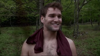 Movie still from “V/H/S” (2012), directed by Joe Swanberg – A man with a towel around his neck and chest; Medium shot, Low angle