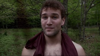 Movie still from “V/H/S” (2012), directed by Joe Swanberg – A man with a beard and a towel around his neck; Close Up shot, Low angle