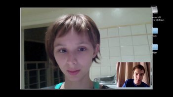 Movie still from “V/H/S” (2012), directed by Joe Swanberg – A young woman is taking a selfie in a kitchen; Close Up shot, High angle