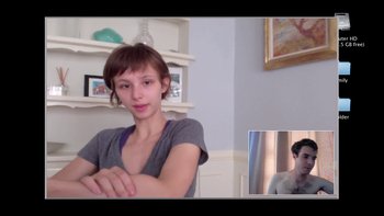 Movie still from “V/H/S” (2012), directed by Joe Swanberg – A young woman sitting in front of a mirror and looking at the camera; Medium shot, Over the shoulder angle