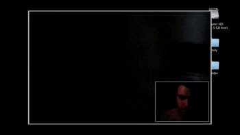 Movie still from “V/H/S” (2012), directed by Joe Swanberg – A man is sitting in front of a black background; Extreme Wide shot, Overhead angle