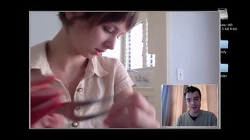 Movie still from “V/H/S” (2012), directed by Joe Swanberg – A young woman holding a pair of shears while a young man looks on; Close Up shot, Over the shoulder angle